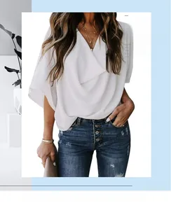 Detail of white cowl neck chiffon top featuring a layered contrast two-piece design