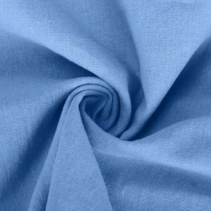 Macro shot of blue cotton linen fabric showing plain weave texture and fiber density