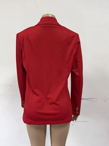 Detail view of red blazer back with slimming seams and decorative cuff buttons
