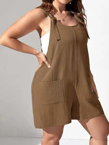 Detail of dark brown spaghetti strap romper with bow ties and large front pockets