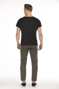 Back view of a man wearing dark gray casual T-shirt and olive green trousers in studio