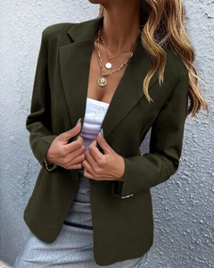 Close-up of olive green blazer fabric texture and polished single-button detail