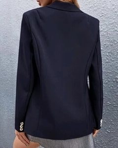 Rear view of navy blue women's blazer showing tailored fit and gold cuff buttons