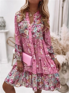 Détail d'une robe bohème rose à fleurs avec ourlet à volants et décolleté en V