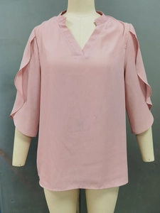 Detailed view of the layered ruffle sleeves and V-neckline on this pink chiffon top