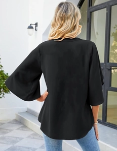 Back view of a loose black chiffon blouse featuring bell sleeves and curved hem design