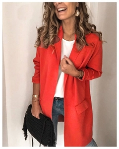 Detail of red lapel cardigan jacket with decorative flap pockets for a stylish look