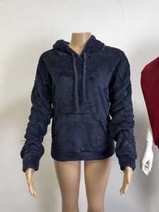 Detail view of the thick navy blue lamb velvet texture and cozy kangaroo pocket