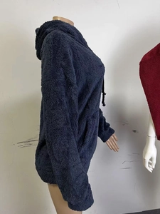 Detail view of navy teddy fleece hoodie showing thick plush fabric and side pocket