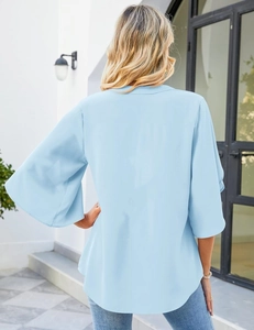 Detail of light blue chiffon top featuring flared petal sleeves and loose V-neck design