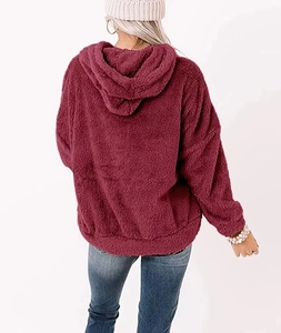 Close-up of plush burgundy sherpa hoodie showing soft texture and cozy oversized hood