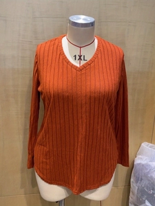 Detail of V-neck orange ribbed knit top with long sleeves in plus size 1XL fit