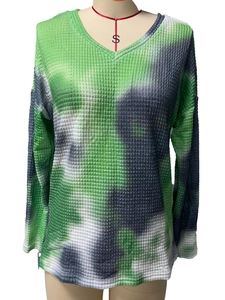 Close-up of waffle knit texture and green tie-dye pattern on long sleeve V-neck top