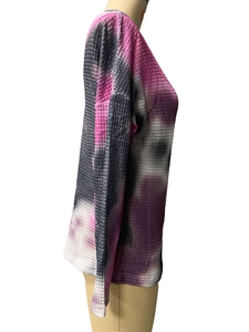 Close-up of pink and black tie-dye waffle knit texture on long sleeve V-neck top
