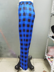 Detailed side view of blue and black plaid straight-leg trousers with elastic drawstring waist