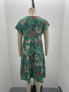 Detailed back view of dark green floral print dress with tiered cake skirt layers