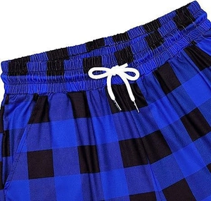 Detail view of elastic waistband with white drawstring on blue plaid lounge pants