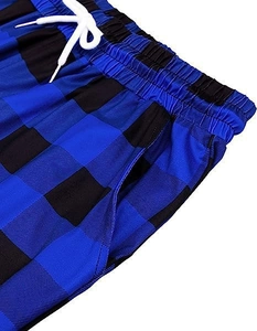 Detail of blue plaid pajama pants featuring an elastic waistband and white drawstring