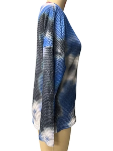 Close-up of the waffle knit texture and blue tie-dye pattern on this loose fitting top