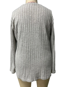 Detail view of the gray ribbed knit texture and back stitching of the long sleeve top