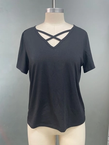 Detail of black V-neck t-shirt with stylish criss-cross lace-up design on the neckline