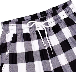 Detail of checkered casual pants featuring an elastic drawstring waistband and soft fabric