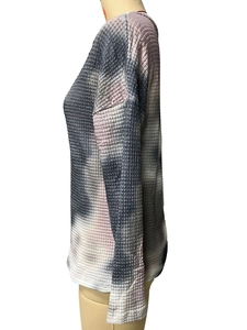 Detailed close-up of waffle knit texture and grey-pink tie-dye pattern on long sleeve top