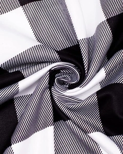 Macro shot of black and white buffalo check plaid fabric texture with soft drape