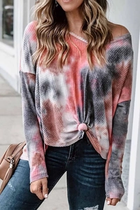 Detail of waffle knit fabric texture and pink grey tie dye pattern on a long sleeve top