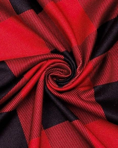 Macro detail of red and black buffalo plaid fabric showing soft twill weave texture