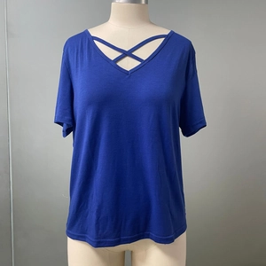 Detail of royal blue T-shirt featuring a stylish criss-cross V-neckline design