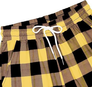 Close-up of elastic waistband with white drawstring on yellow checkerboard lounge pants