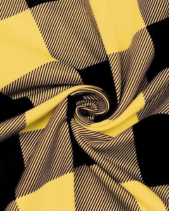 Detail shot of yellow and black buffalo plaid fabric texture on casual trousers