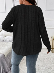 Rear view of long sleeve black ribbed knit top with relaxed fit and dropped shoulders