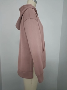 Side view of mauve oversized hoodie featuring a high-slit hem and large kangaroo pocket
