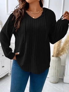 Detail of black V-neck hooded ribbed knit top featuring soft texture and cozy long sleeves