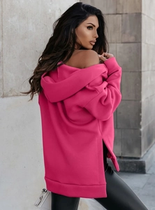 Detail view of pink oversized hoodie showing unique side slit and heavy fabric texture