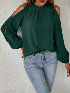 Detail view of cold-shoulder cutouts and ruffled high neck on dark green long sleeve blouse