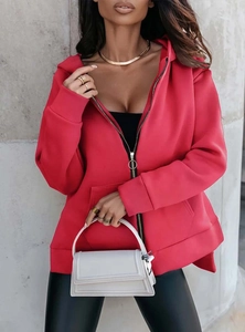 Detail of red hoodie with golden circular zipper puller and side slit hem design