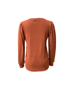 Détail du haut en maille caramel avec manches bouffantes et texture côtelée verticale