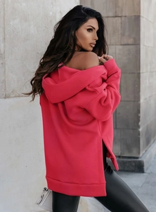 Macro detail of the rose red hoodie featuring side slits and thick premium knit fabric