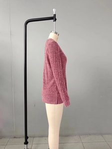 Vue détaillée de la maille côtelée et du poignet de ce pull rose à col en V pour femme