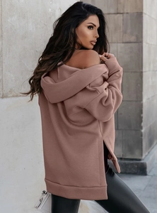 Detail shot of oversized dusty pink hoodie with unique side slit design and soft fabric