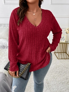 Detail of red V-neck ribbed knit long sleeve shirt with soft brushed texture