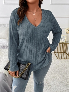 Detail of grey-blue V-neck ribbed long sleeve top showing fabric texture and casual fit