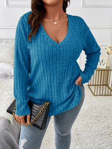 Detail of blue V-neck ribbed knit top with vertical texture and loose fit for women