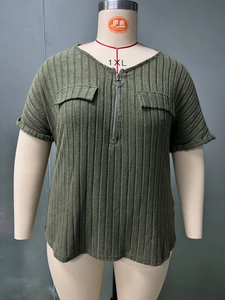 Detail of army green plus size top showing half-zip neckline and decorative pocket flaps