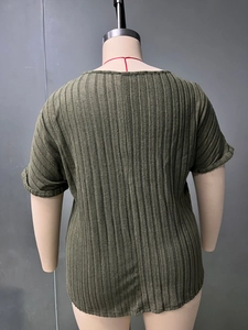 Detailed texture of olive green ribbed knit fabric on women's loose casual t-shirt top