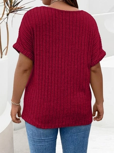 Detail view of the wine red ribbed knit texture and cuffed short sleeves on a summer top