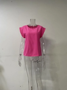 Detalle de blusa rosa con pliegues de acordeón en las mangas cortas y diseño de cuello redondo